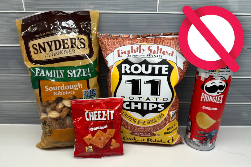 A collection of snack food bags and a Pringles can with a red 'no' symbol overlaid, indicating they are not accepted for recycling.